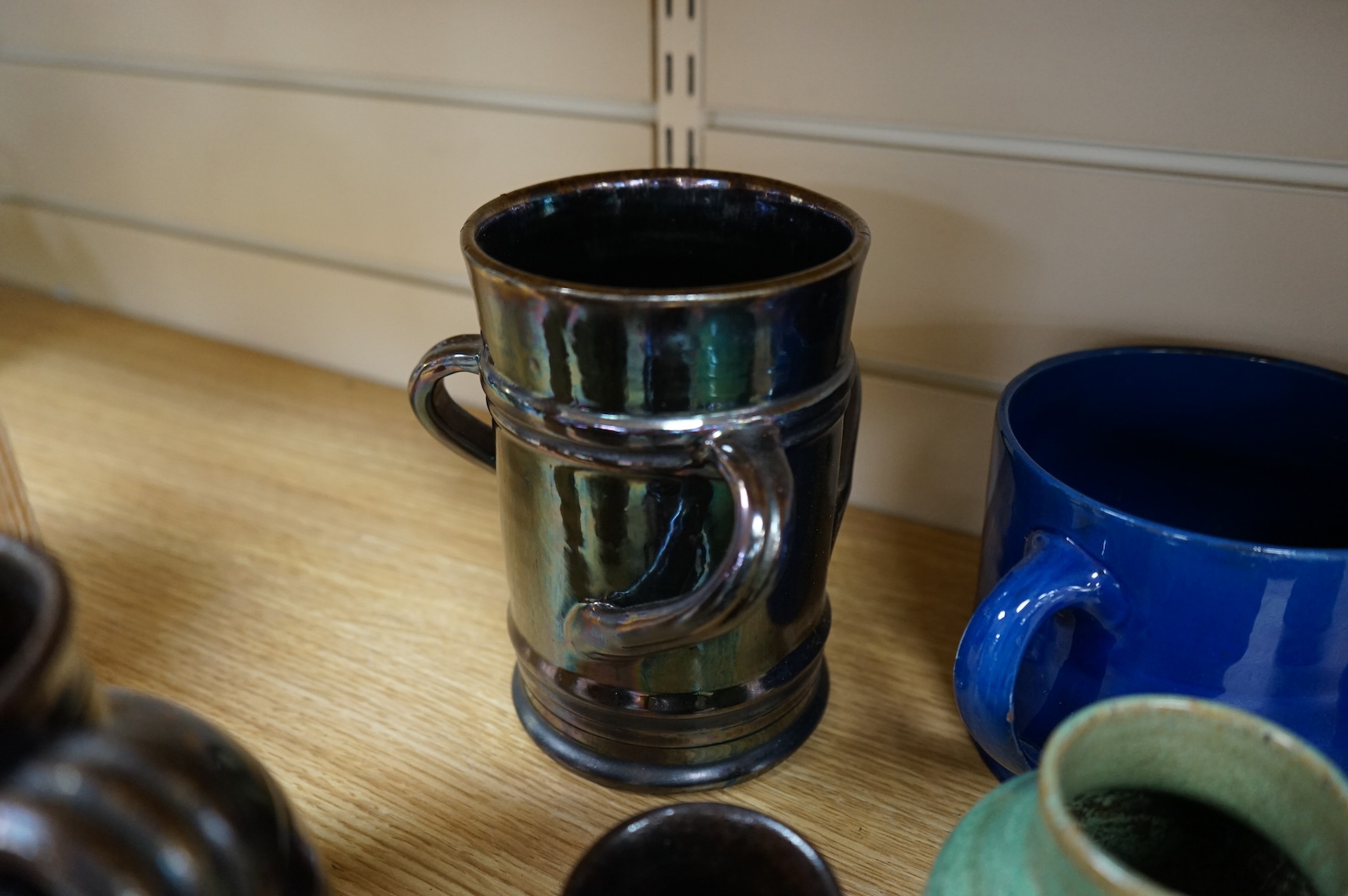 A collection of pottery to include lustre glazed jugs and tygs, a T. G. Green storage jar, Carltonware ash tray and a miniature Ruskin style vase, largest 18cm high